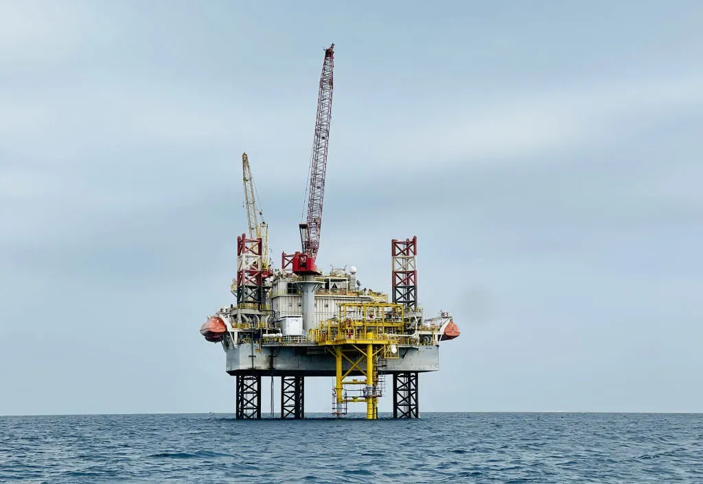 A crane ship helps other vessels searching for oil and natural gas near the oil platform offshore the Red Sea in Ras Behar region, Egypt.