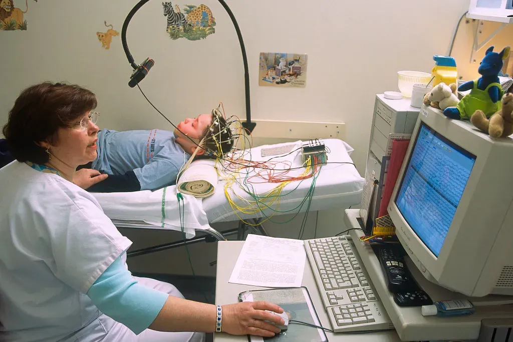 The Technician Reads Eeg Data While Subjecting The Boy To A Variety Of Visual And Respiratory Stimuli Stroboscopy.