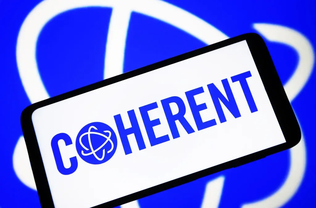 In this photo illustration, a Coherent Corp. logo is seen on a smartphone screen and in the background. 