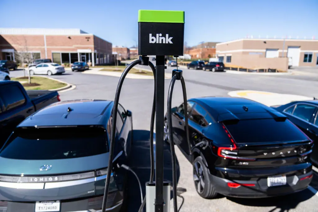 Electric vehicles charge outside of Blink Charging's new flagship manufacturing facility in Bowie, Md., on Monday March 11, 2024.