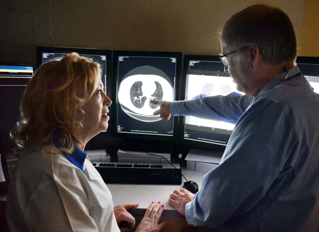 Division of Pulmonology and Critical Care nurse practitioner Jeanne Millett, left, and pulmonologist Dr. Thomas Smith review lung cancer screening scans.