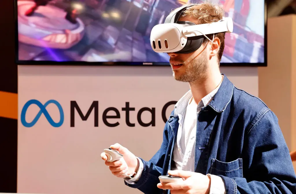 A visitor wears a virtual reality headset Meta Quest as he takes part in an immersive experience.