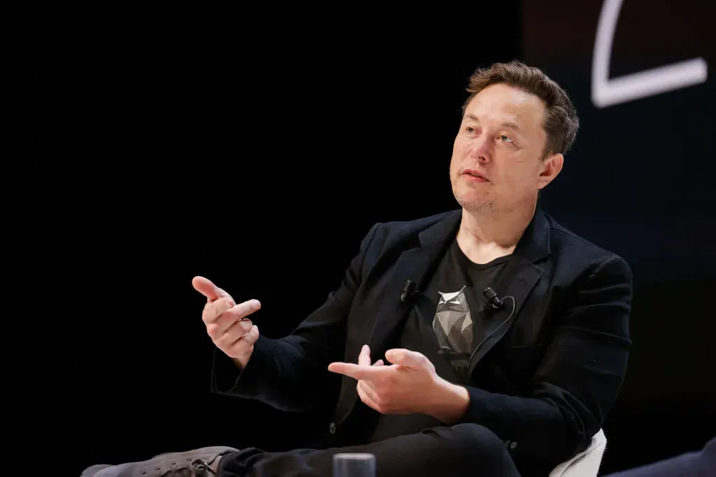 Elon Musk speaks onstage during the "Exploring the New Frontiers of Innovation: Mark Read in Conversation with Elon Musk" session at the Lumiere Theatre.