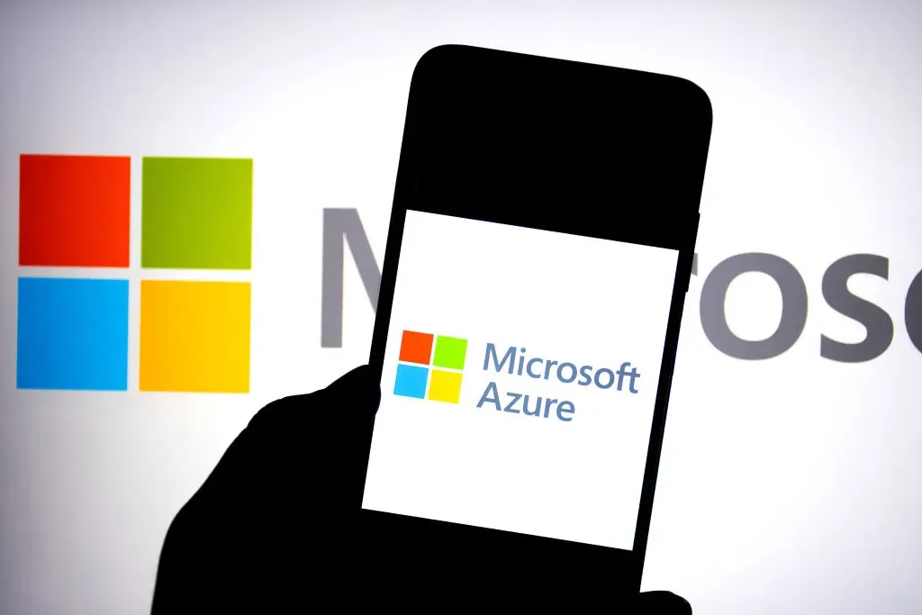 In this photo illustration, a Microsoft Azure logo is seen displayed on a smartphone with a Microsoft logo in the background.