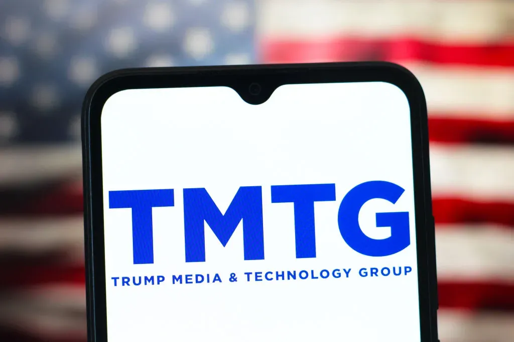In this photo illustration, the TMTG (Trump Media & Technology Group) logo is seen displayed on a smartphone screen.