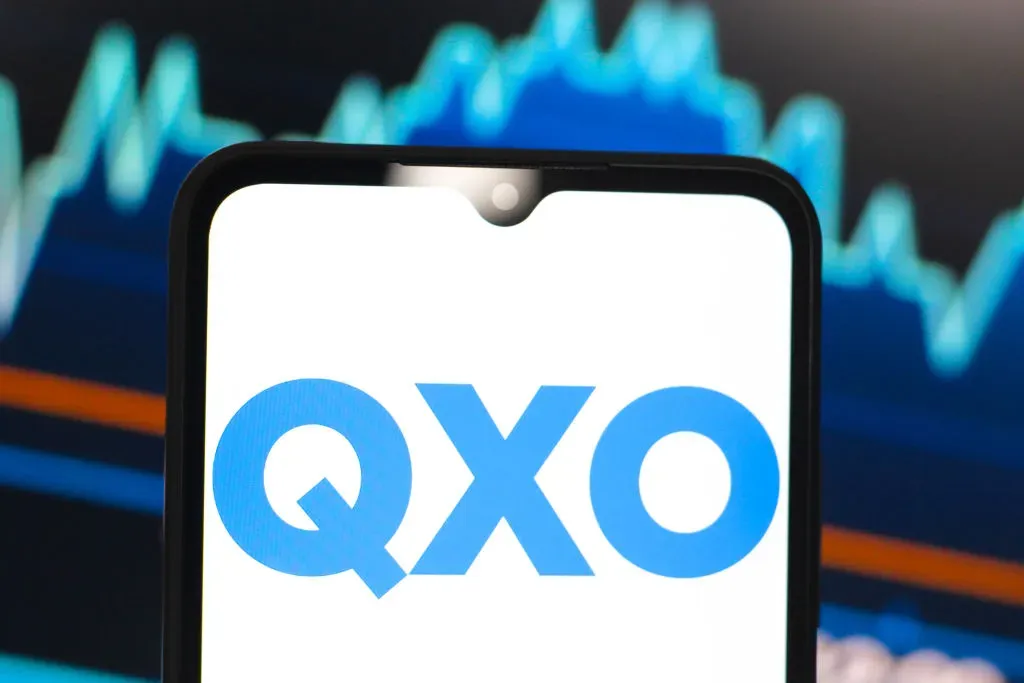 In this photo illustration, the QXO logo is seen displayed on a smartphone screen.