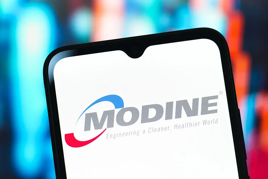 In this photo illustration, the Modine Manufacturing Company logo is seen displayed on a smartphone screen.