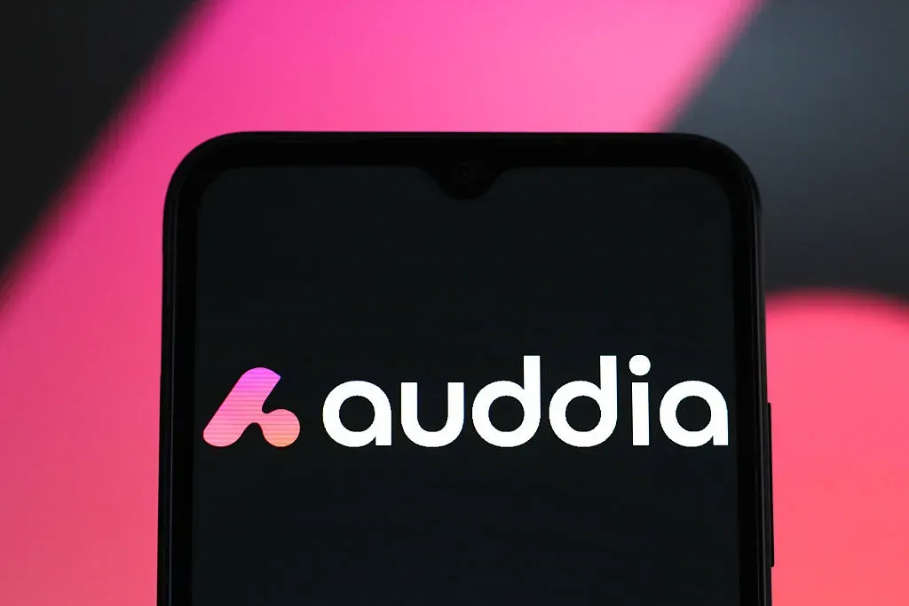 In this photo illustration, the Auddia logo is seen displayed on a smartphone screen.