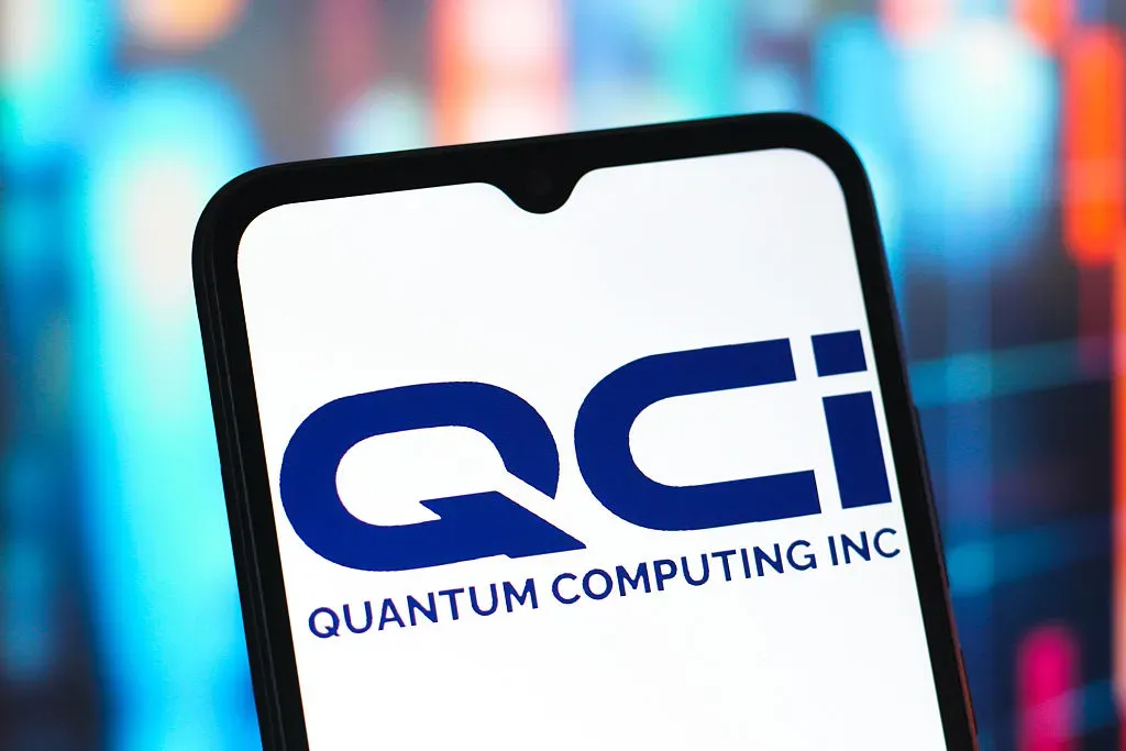 In this photo illustration, the QCI (Quantum Computing) logo is seen displayed on a smartphone screen.