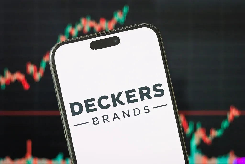 In this photo illustration, the logo of Deckers Outdoor Corporation is displayed on a smartphone screen.