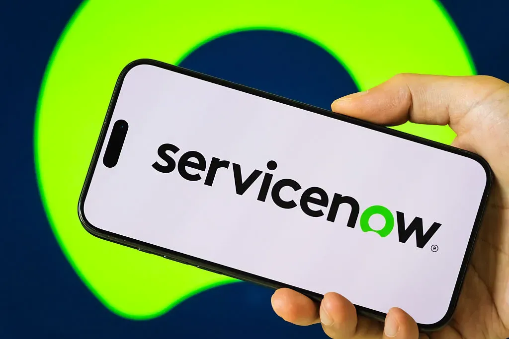 In this photo illustration, a person holds a smartphone displaying the logo of ServiceNow Inc. 