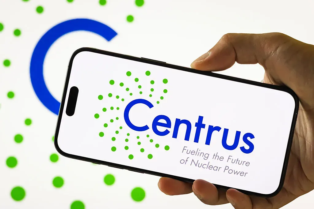 In this photo illustration, a person holds a smartphone displaying the logo of Centrus Energy Corp.