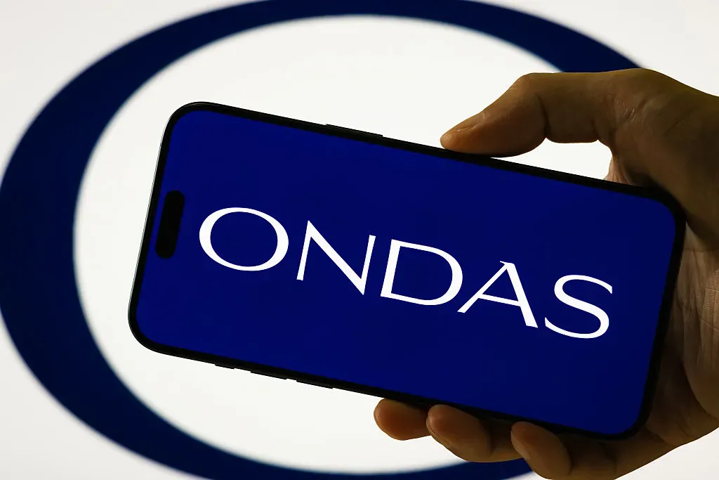 In this photo illustration, a person holds a smartphone displaying the logo of Ondas Holdings Inc. 