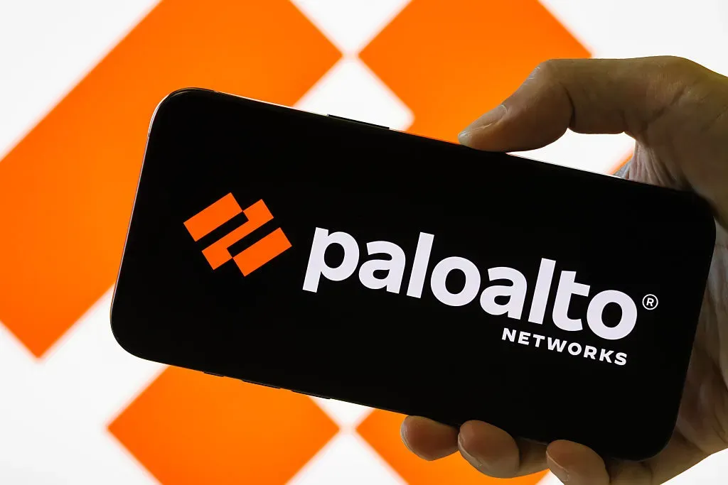 In this photo illustration, a person holds a smartphone displaying the logo of Palo Alto Networks Inc.