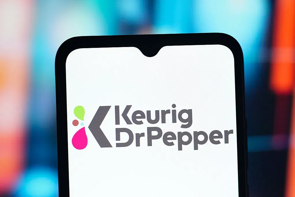 In this photo illustration, the Keurig Dr Pepper logo is seen displayed on a smartphone screen.