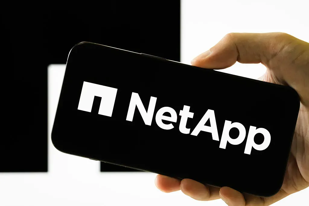  In this photo illustration, a hand holds a smartphone displaying the logo of NetApp Inc.