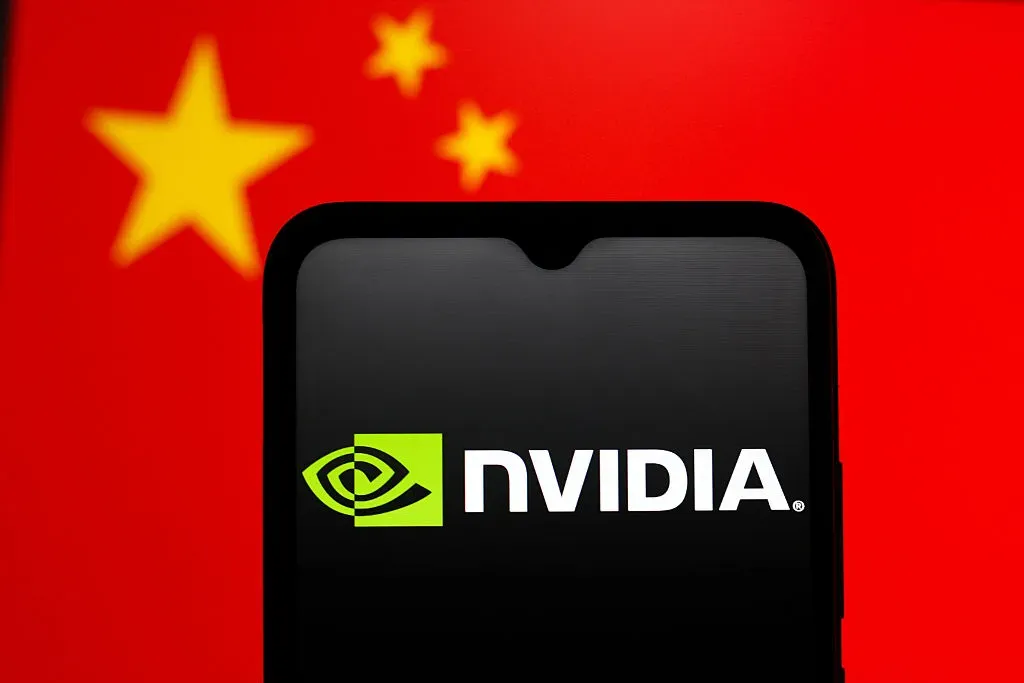 In this photo illustration, the Nvidia Corporation logo is seen displayed on a smartphone screen and the Chinese flag in the background. 