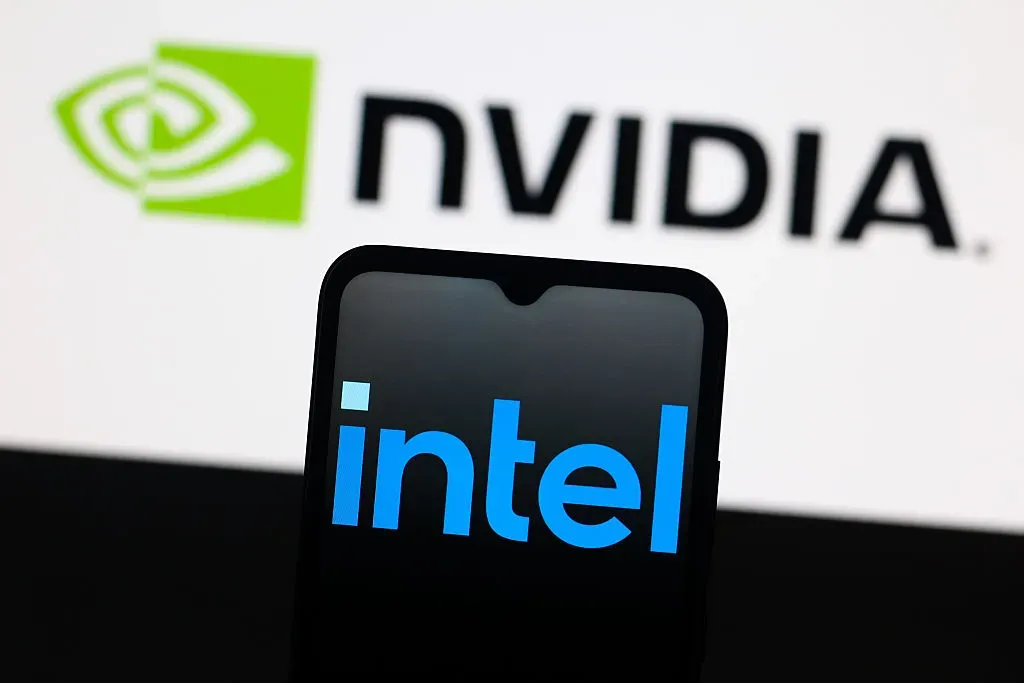 In this photo illustration, the Intel logo is seen displayed on a smartphone screen and the Nvidia logo in the background.