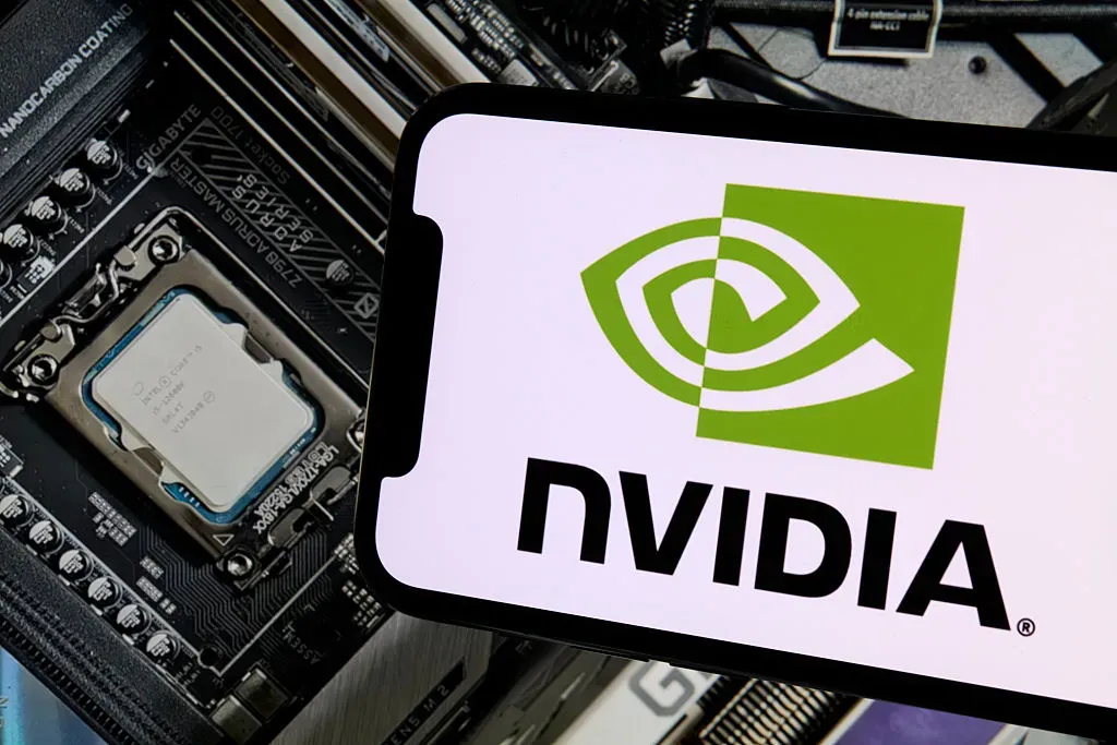 The NVIDIA logo appears on a smartphone screen with a GeForce GPU in the background, illustrating branding and technology context.