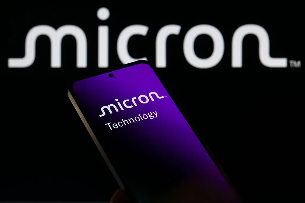The Micron Technology Ink logo is displayed on a mobile phone with the company branding visible in the background, in this photo illustration in Brussels, Belgium, on December 14, 2025. 