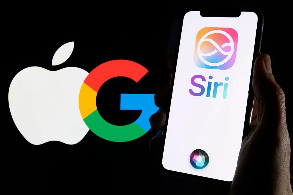 A user holds an iPhone showing Siri and Apple Intelligence logos in front of the Apple and Google logos.