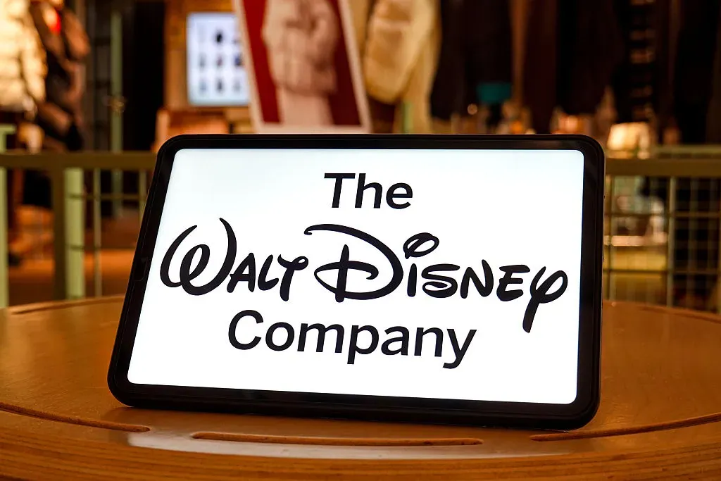 In this photo illustration, the Walt Disney Company logo is seen displayed on the screen of a tablet.