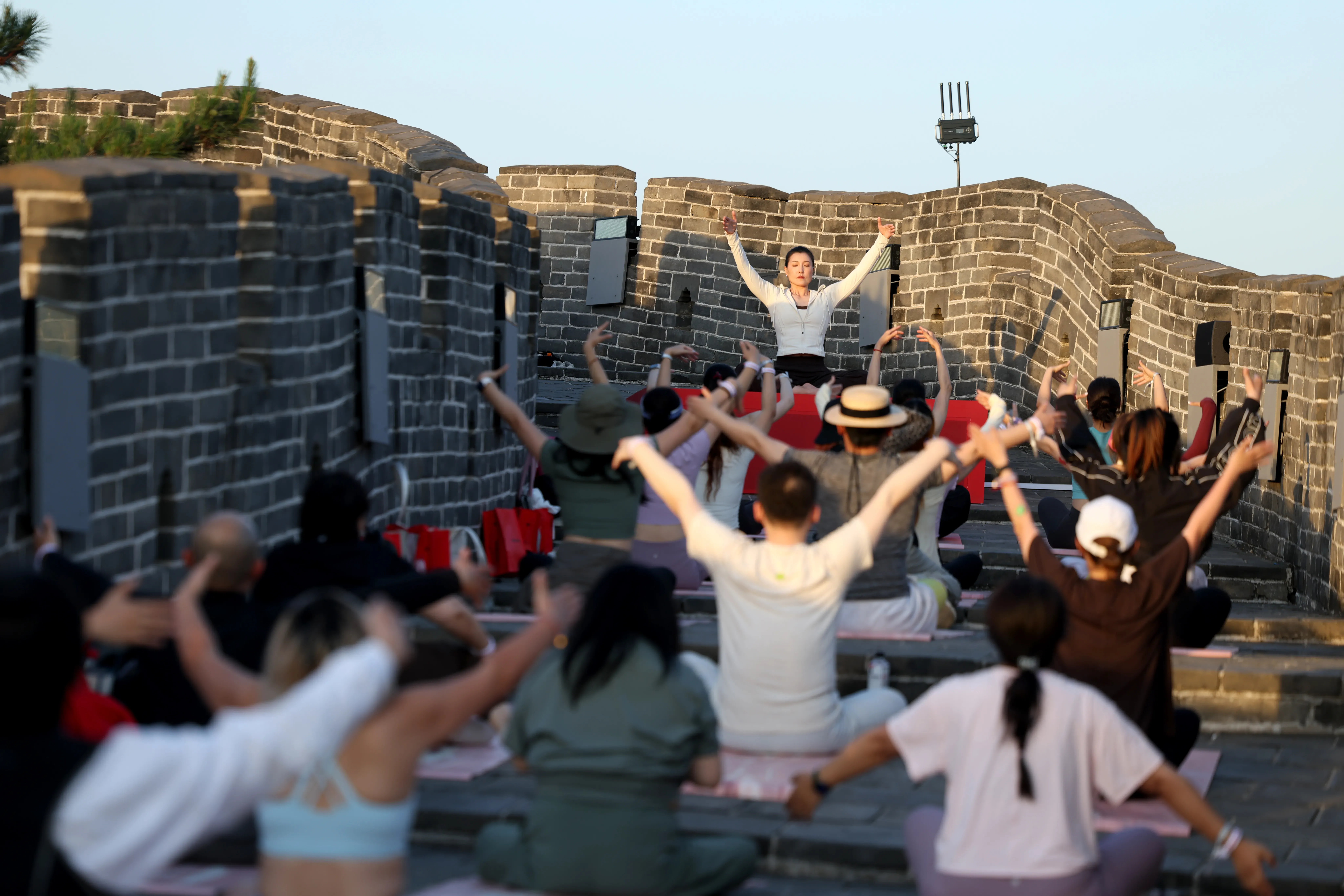 Yoga enthusiasts practice in a tai chi-yoga session at the Huanghuacheng Lakeside Great Wall on May 30, 2026 in Beijing,