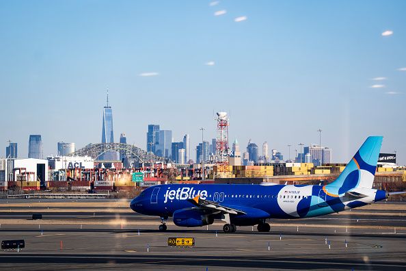 An Airbus A320 plane, operated by JetBlue Airlines at Newark Liberty International Airport (EWK) in front of the skyline of lower Manhattan and One World Trade Center in New York City on January 15, 2026 in Newark, New Jersey. (Photo by Al Drago/Getty Images)