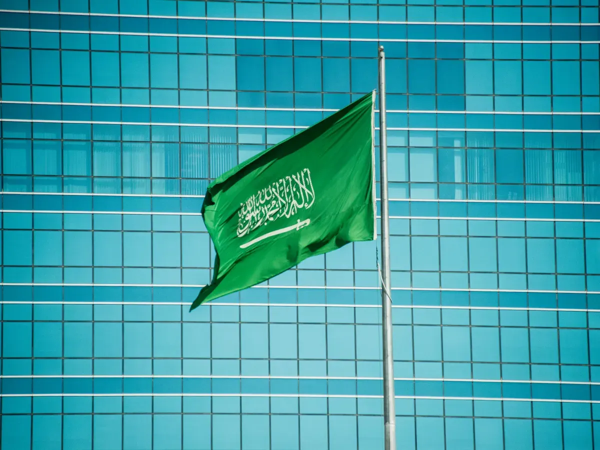 Low angle view of a large national flag of the Kingdom of Saudi Arabia by the Kingdom Centre skyscraper in Riyadh, Saudi Arabia.
