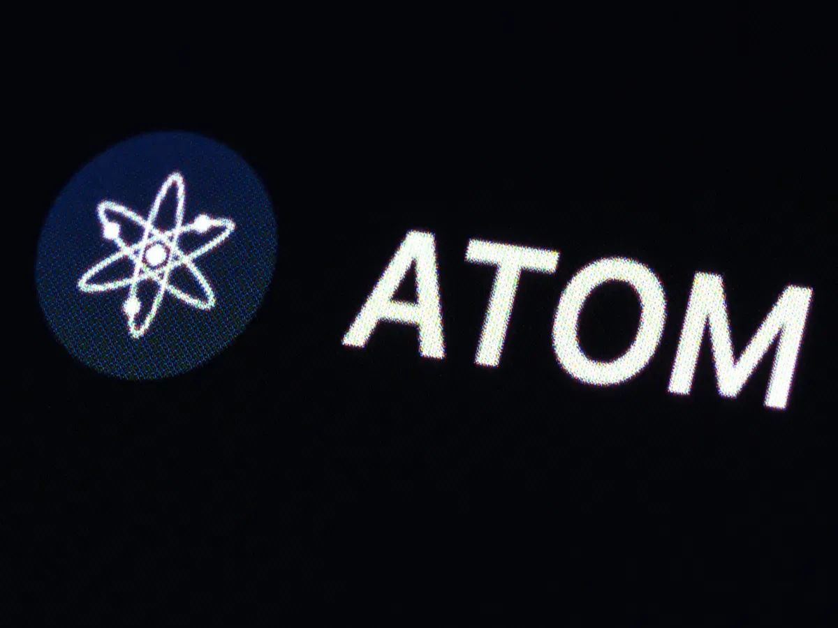 The logo of the cryptocurrency Cosmos (ATOM) can be seen on the CoinMarcetCap trading platform. Photo: Silas Stein/dpa (Photo by Silas Stein/picture alliance via Getty Images)