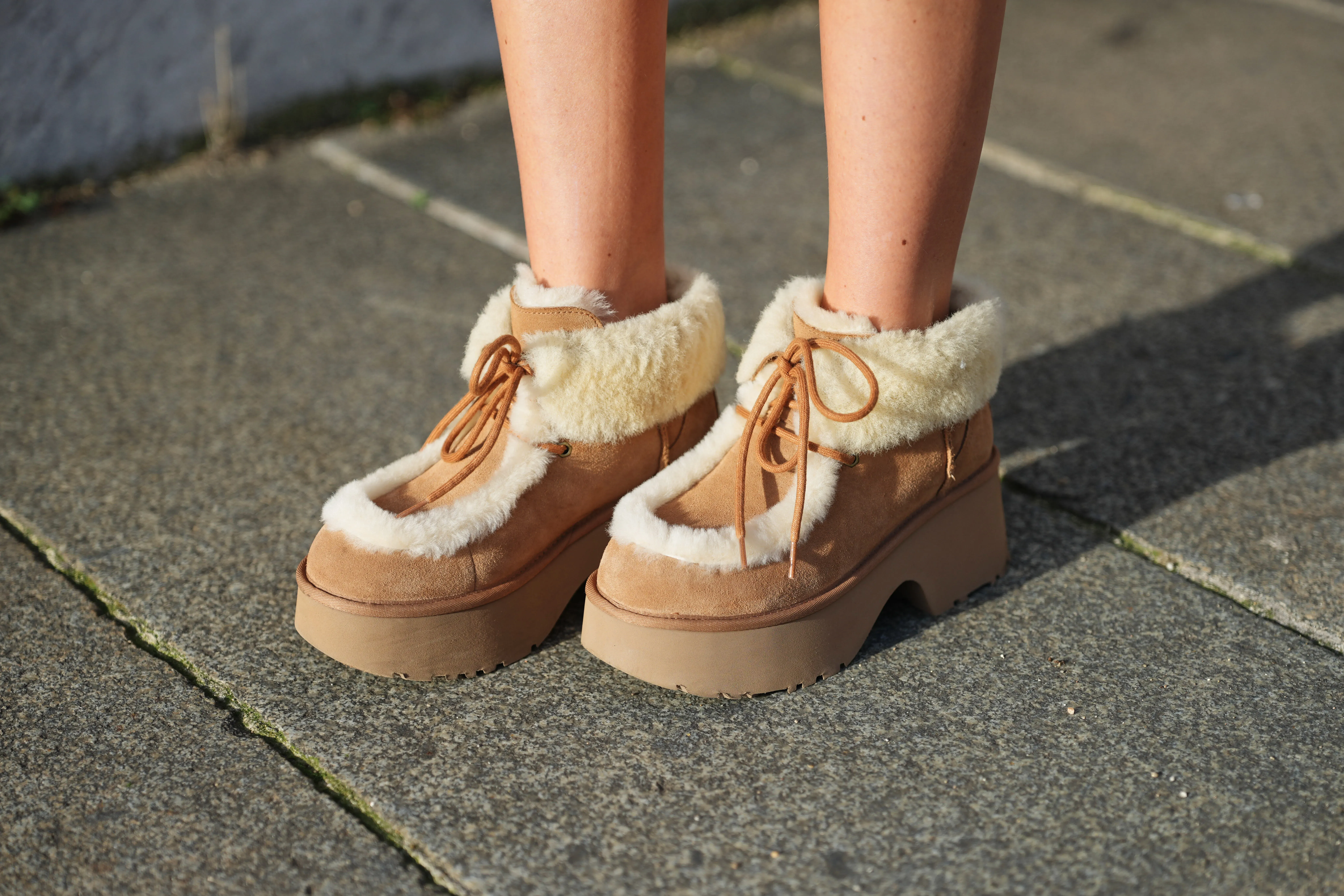 Gabriella Berdugo wears beige shearling lined platform boots by Uggs, during a street style fashion photo session, on December 09, 2025 in Paris, France.