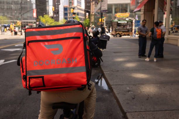 A delivery worker carries a DoorDash bag in New York, US, on Monday, April 29, 2024. DoorDash Inc. is scheduled to release earnings figures on May 1. Photographer: Yuki Iwamura/Bloomberg via Getty Images