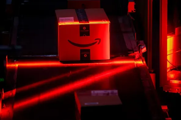 An automated bar code reader scans packages prepared for shipping at an Amazon fulfillment center on Cyber Monday in New Jersey, US, on Dec. 1, 2025.