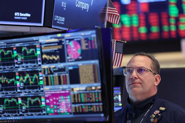 A trader works on the floor of the New York Stock Exchange (NYSE) at the opening bell in New York on March 24, 2026. European and US stocks resumed sliding and oil prices jumped on Tuesday as traders turned cautious over the prospect of a negotiated agreement between the United States and Iran to end the Middle East war. (Photo by ANGELA WEISS / AFP via Getty Images)