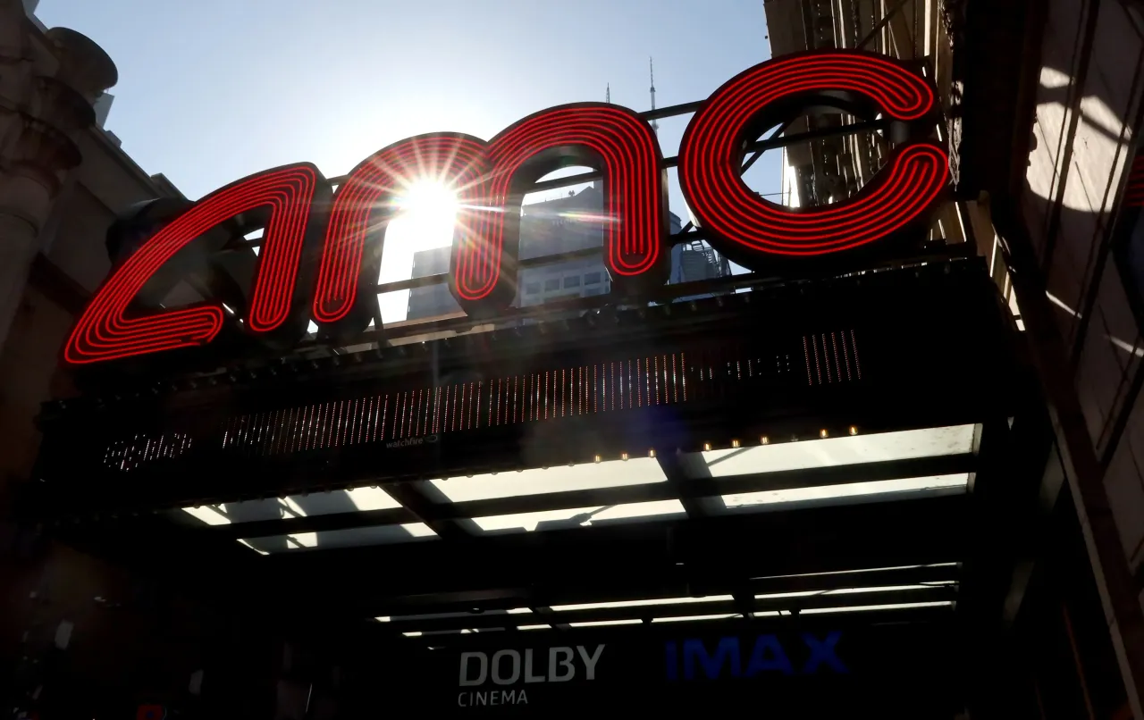 The sun shines through a corporate logo at an AMC movie theater on 42nd Street in Times Square on June 24, 2025, in New York City. 