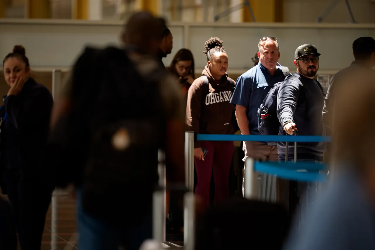 Travelers wait to check in for their flights at Ronald Reagan Washington National Airport on May 23, 2025 in Arlington, Virginia. 