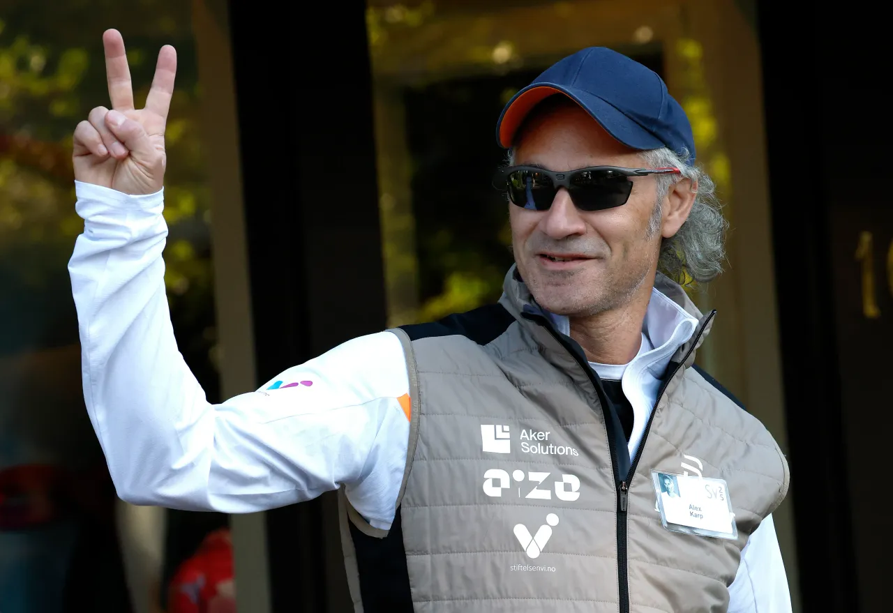 Alex Karp, CEO of Palantir Technologies, talks to members of the media as he walks to a morning session at the Allen & Company Sun Valley Conference on July 10, 2025, in Sun Valley, Idaho. 