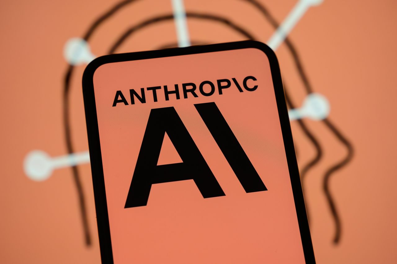The Anthropic logo is displayed on the screen of a smartphone with the company's branding in the background. (Photo by Samuel Boivin/NurPhoto via Getty Images)