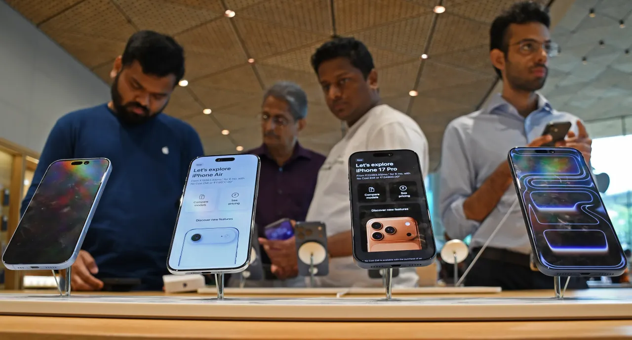 People check models of iPhone 17 series kept on display inside the Apple store at Jio World Drive mall at Bandra Kurla Complex (BKC).