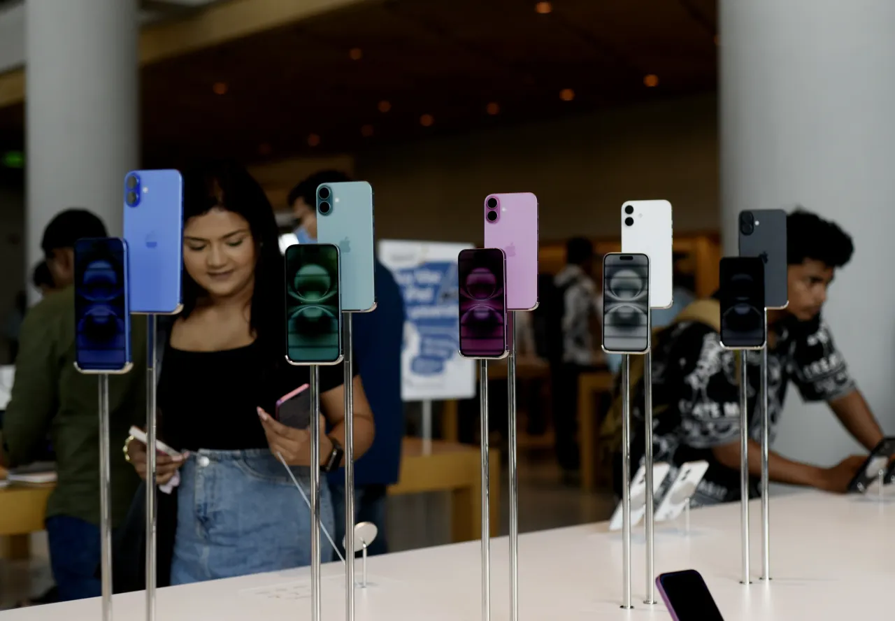 Customers browse iPhone 16 on the launch day of the iPhone 16 series at Apple BKC, in Mumbai, India, on September 20, 2024. 