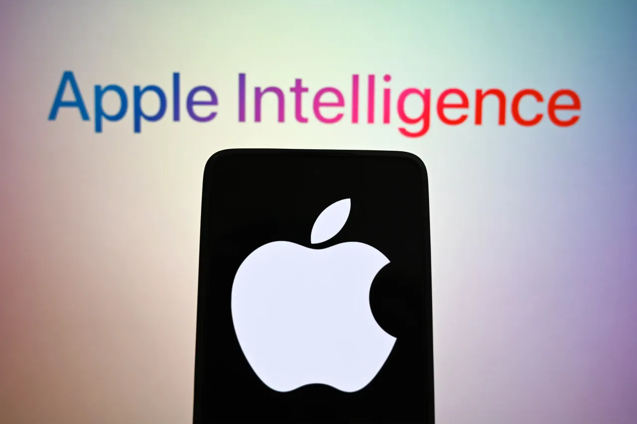 In this photo illustration, Apple logo is seen on a smartphone screen and Apple Intelligence logo of an artificial intelligence (AI) in the background. 