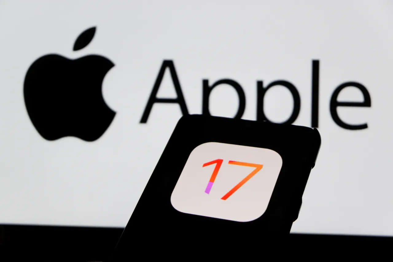  In this photo illustration, the IOS 17 Iphone logo displayed on a smartphone with an Apple logo in the background. 