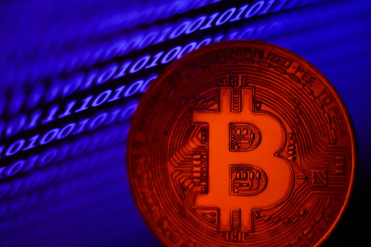 A binary code displayed on a laptop screen and representation of Bitcoin are seen in this illustration photo taken in Krakow, Poland on November 2, 2023. (Photo by Jakub Porzycki/NurPhoto via Getty Images)