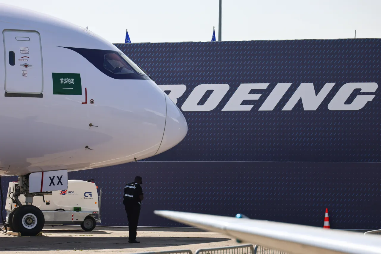 Boeing logo on a pavilion in front of a 787 Dreamliner of Riyadh Air at Paris Air Show.