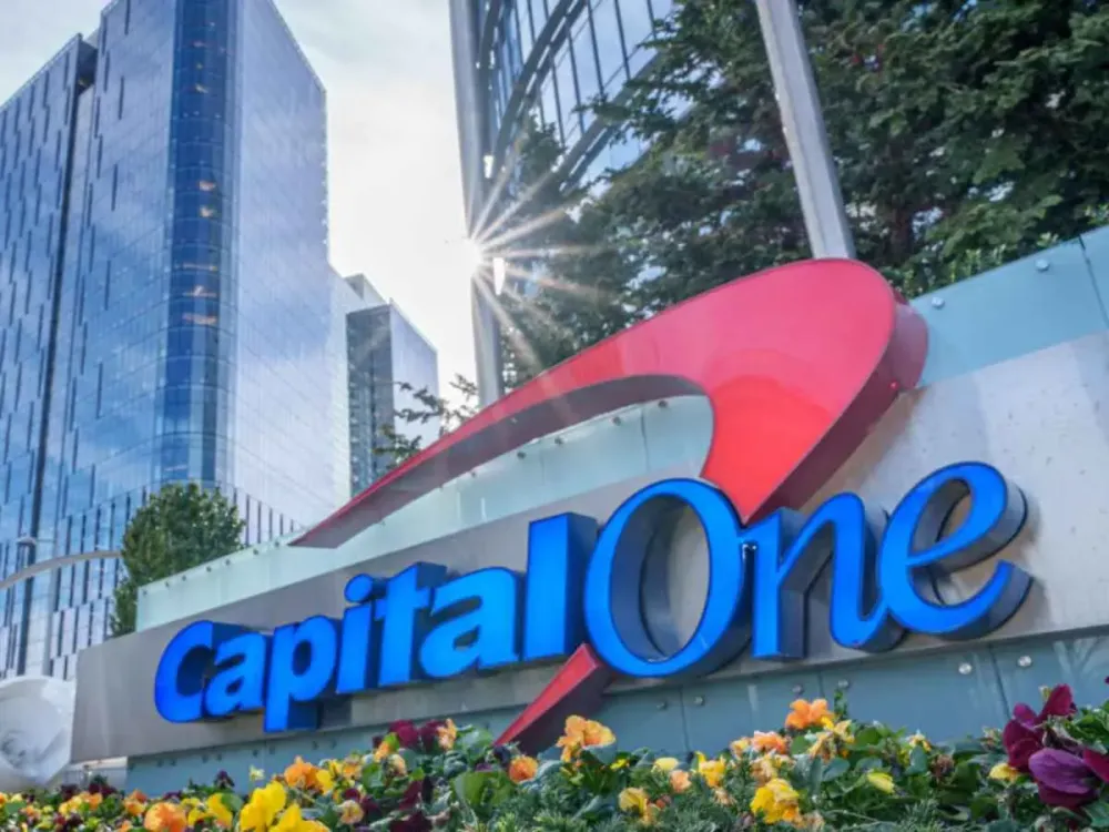The sun flares over the top of the Capital One logo outside of their corporate headquarters complex on February 8, 2024, in McLean, Va. (Photo by J. David Ake/Getty Images)
