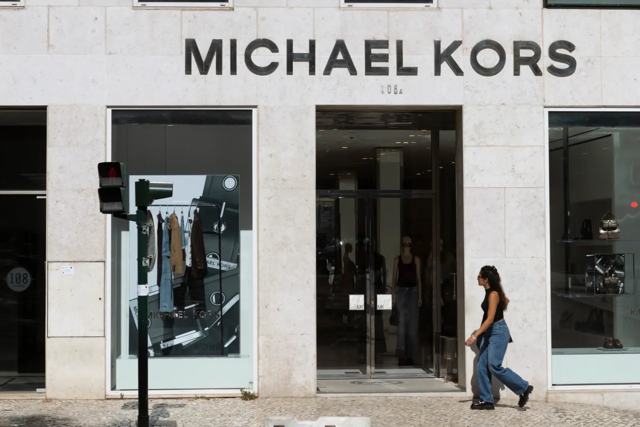 People walk by a Michael Kors store in Lisbon, Portugal, on August 31, 2024. 