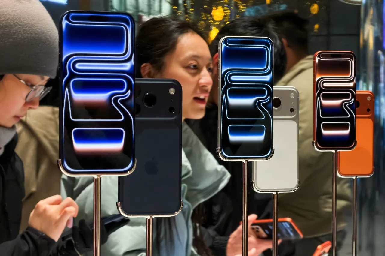 Customers try out iPhone 17 Pro smartphones inside the Apple Store at Sanlitun Taikoo Li on November 8, 2025, in Beijing, China.