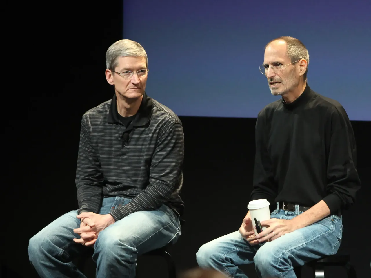 Apple's Steve Jobs and Tim Cook speak at a press conference at Apple headquarters in Cupertino. (Photo by Kimberly White/Corbis via Getty Images)