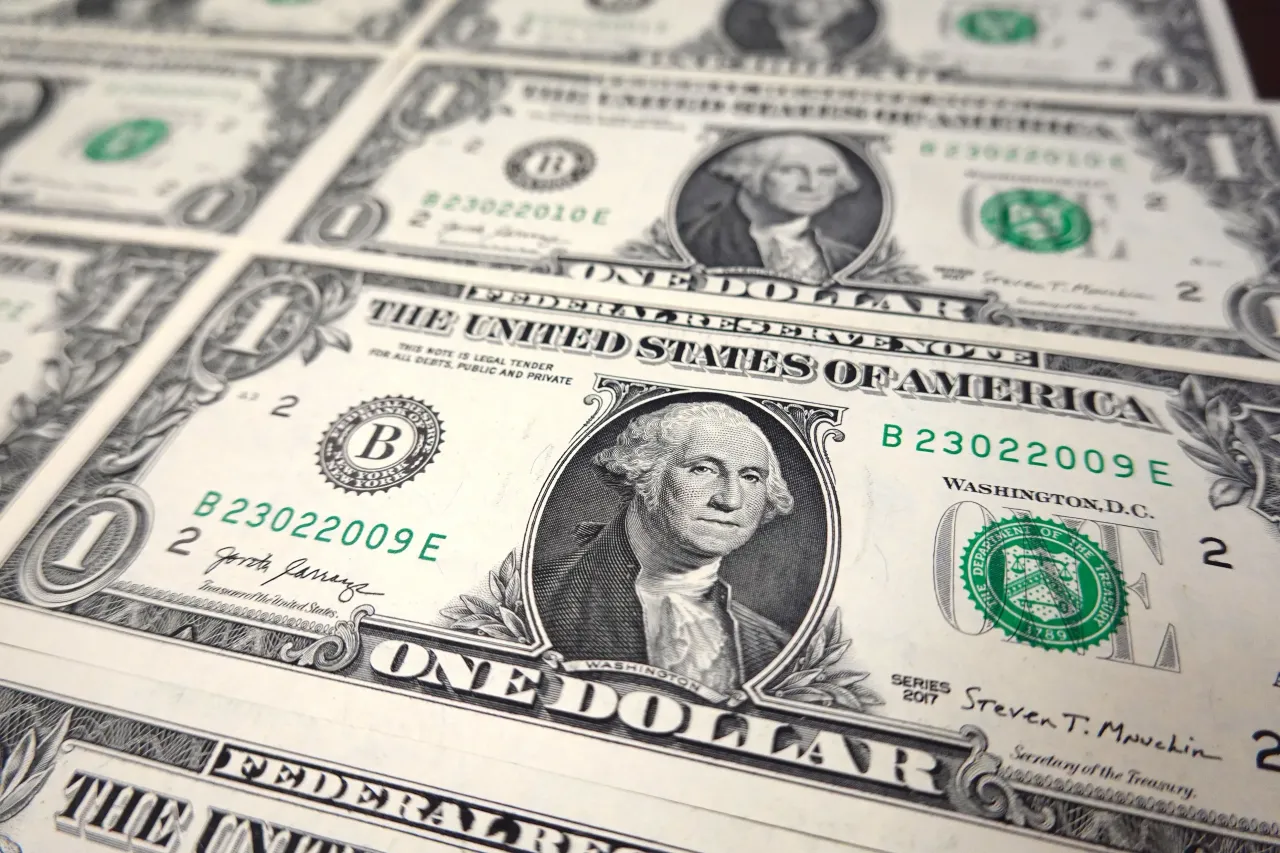 In this photo illustration, several $1 bills are seen displayed showing their front sides. 