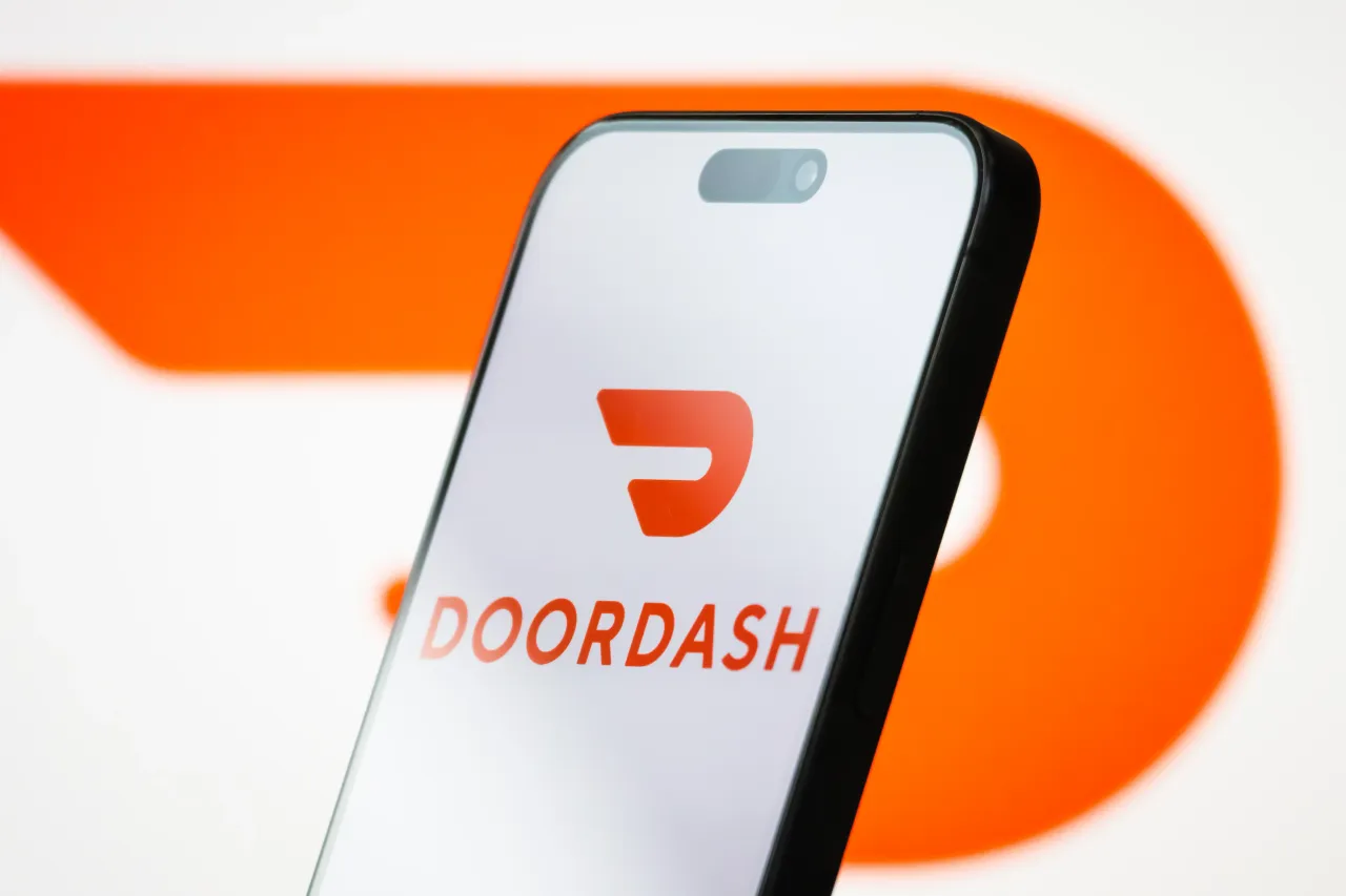 In this photo illustration, the logo of DoorDash, Inc. is displayed on a smartphone screen.